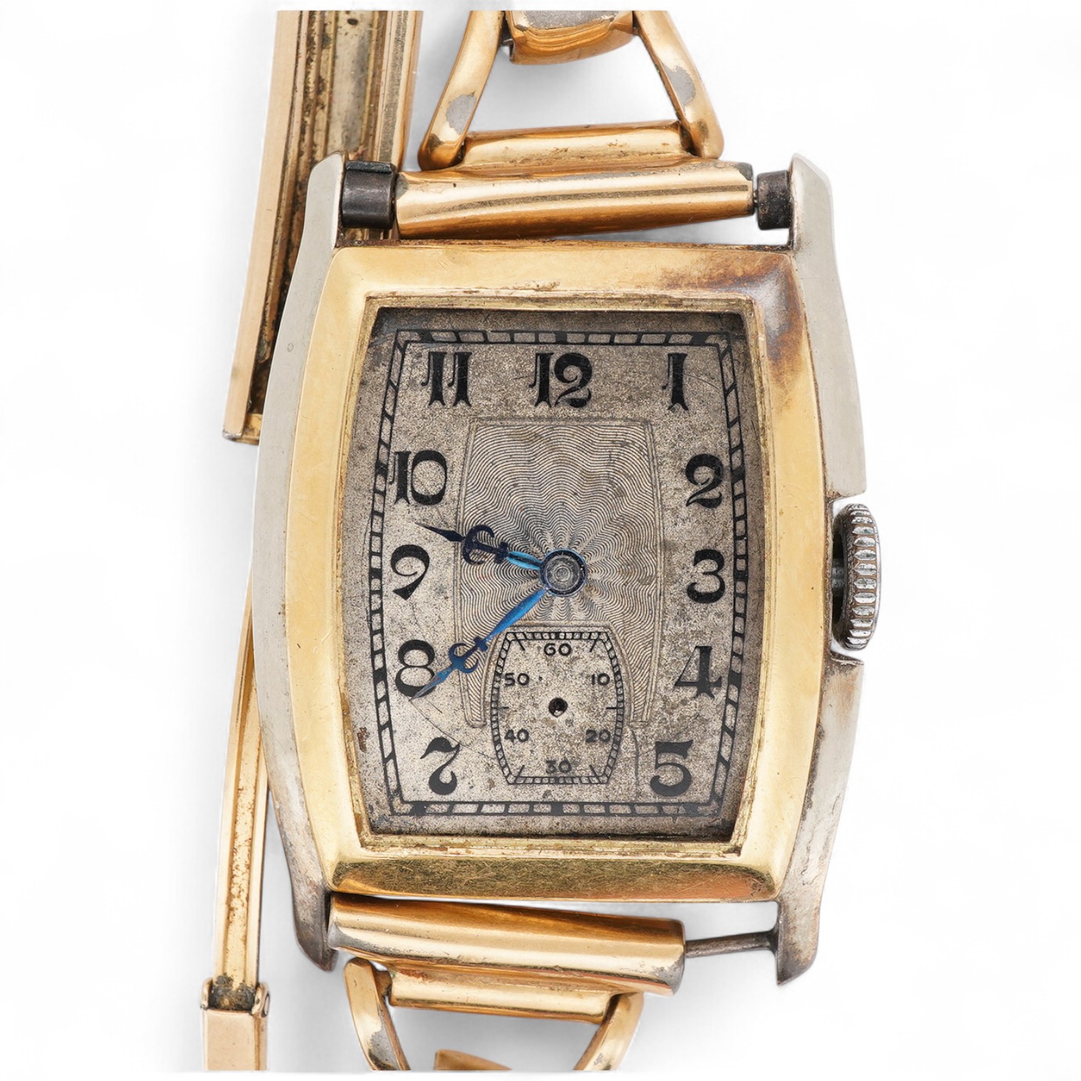 A 1930's Swiss 18ct gold manual wind wrist watch, with tonneau shaped case and Arabic dial with subsidiary seconds, on a gilt metal bracelet, (a.f.).